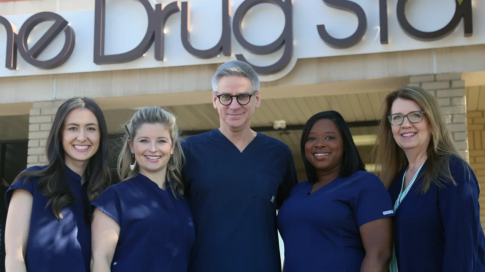 The team in front of The Drug Store