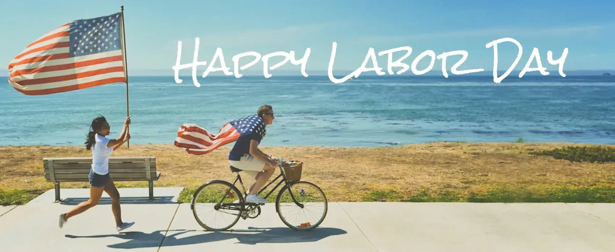 woman and man on beach with US flags, text "Happy Labor Day"