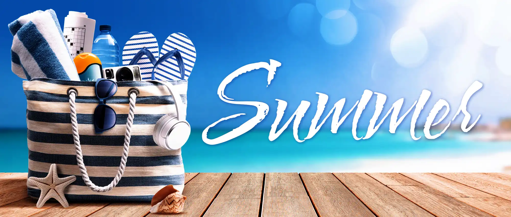 beach bag full of vacation items on dock by sea, text "Summer"